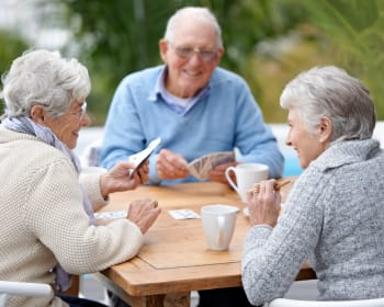 Senior residents playing cards at Kenmore Senior Living in Kenmore, Washington