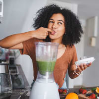 Resident making a smoothie in her fully-equipped kitchen at The Villas at Bryn Mawr Apartment Homes in Bryn Mawr, Pennsylvania