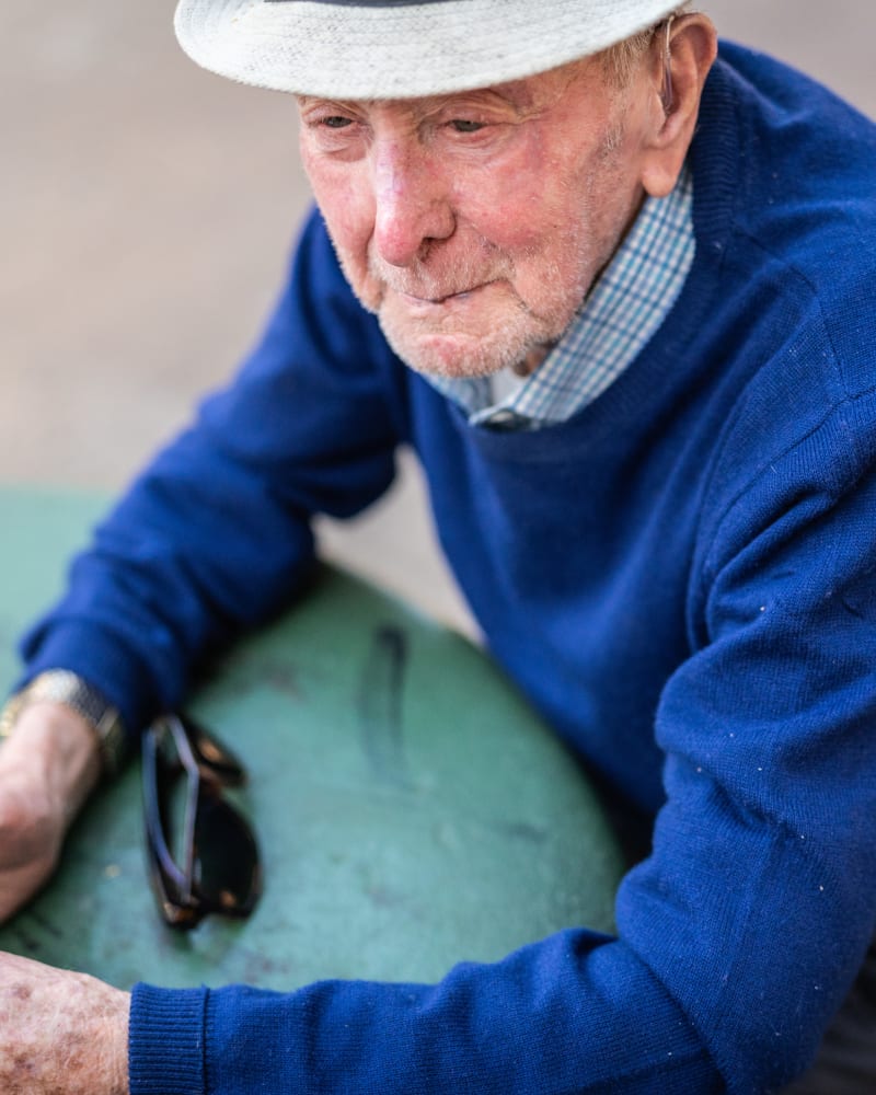 Resident wearing a hat and resting at Governor's Pointe in Mentor, Ohio