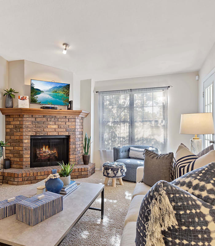 Cozy living room with fireplace at Barrington Apartments in Tulsa, Oklahoma