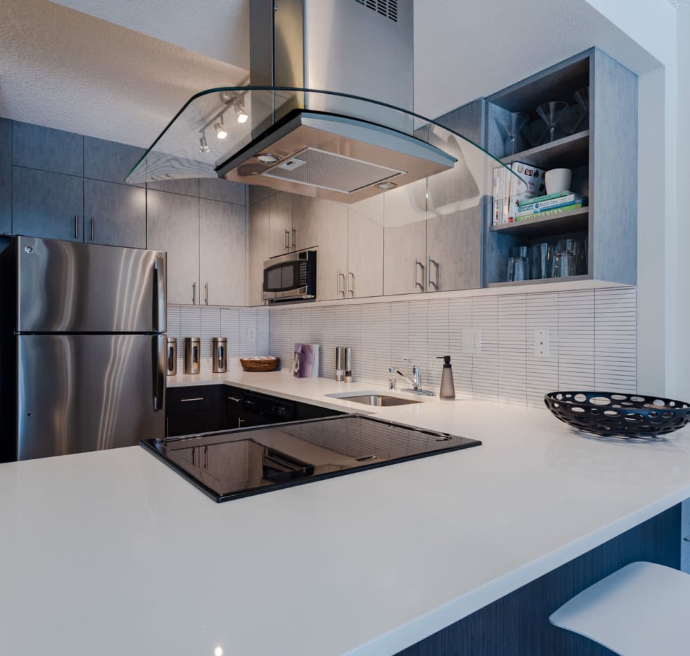 Stainless-steel appliances and an island in a model home's kitchen at Tower 801 in Seattle, Washington