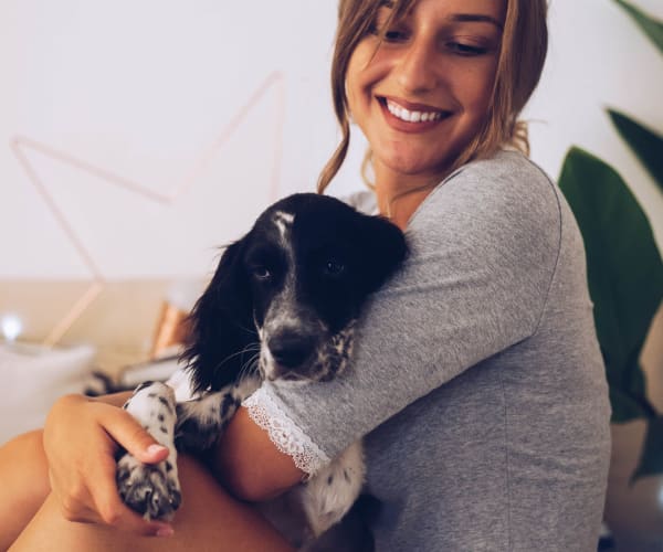 Resident and her dog enjoying their home at TerraLane at Canyon Trails in Goodyear, Arizona