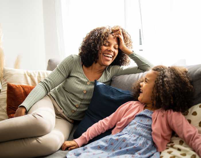 Resident mother with her daughter in a living room at Alamance Reserve in Burlington, North Carolina
