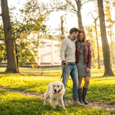 Residents walking with a dog in a local park near Osprey Point in Virginia Beach, Virginia