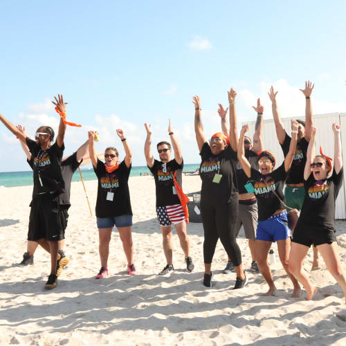 Campus Life & Style colleagues posing for a fun photo at a culture-building event at the beach