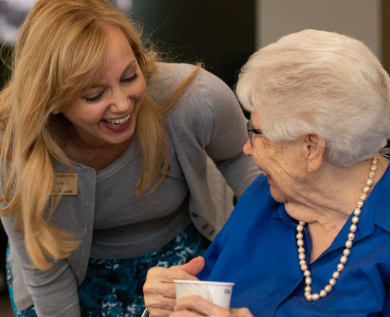 A team member laughing with a resident at Aurora on France in Edina, Minnesota. 