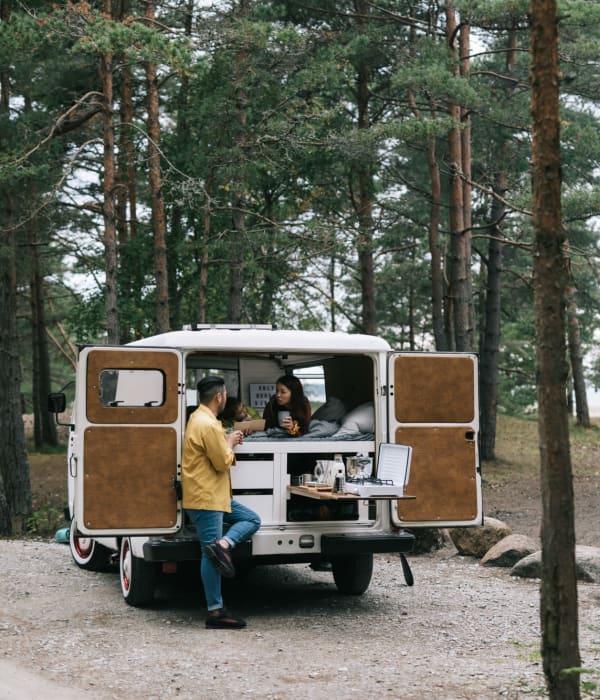 A camping van in a forest area near A-AAAKey - WW White Rd in San Antonio, Texas