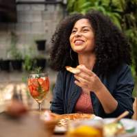 Resident enjoying her food in a restaurant near Timber View Apartments in Grand Haven, Michigan