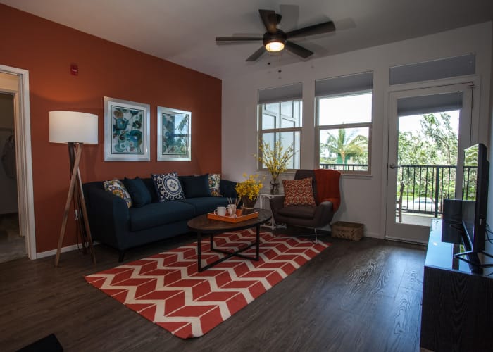 Living room with hardwood floors and ceiling fan at Kapolei Lofts in Kapolei, HI