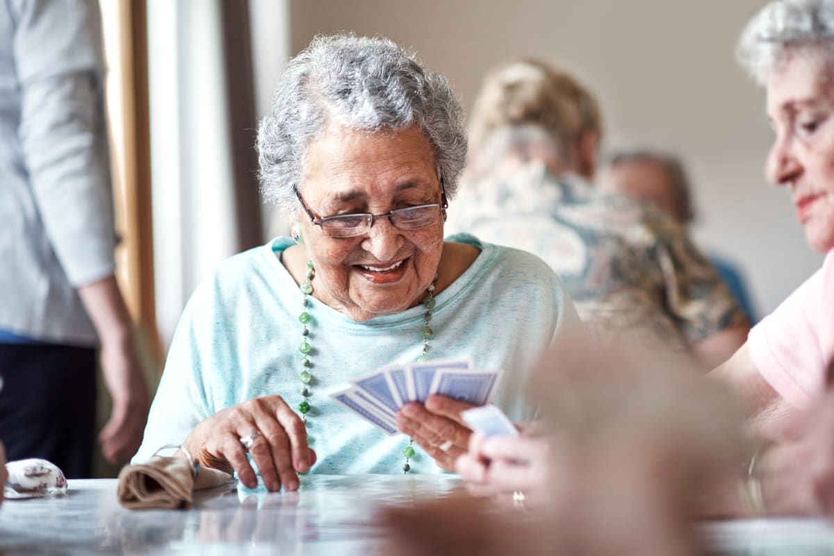 Resident happily playing cards at Madison House in Norfolk, Nebraska