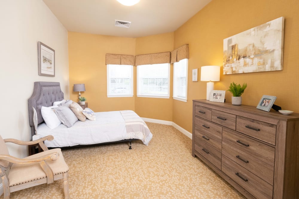 Model bedroom with wood flooring at The Heritage of Meyerland in Houston, Texas
