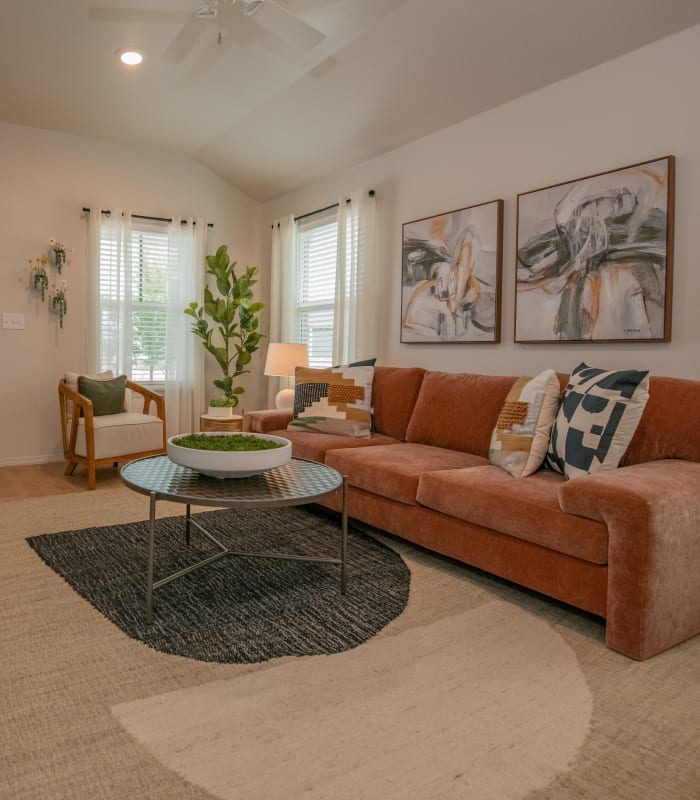 Model living space with velvet couch at Chisholm Pointe in Oklahoma City, Oklahoma