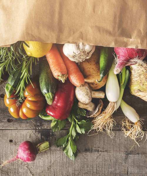 Colorful assortment of fresh vegetables including peppers, carrots at a market near Annika Place II in Traverse City, Michigan