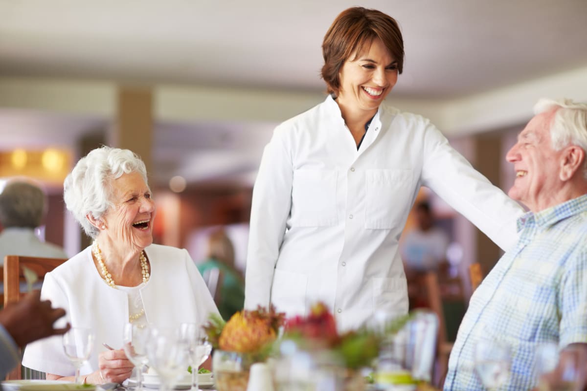 Dining room staff speaking to residents at Gentry Park Orlando in Orlando, Florida