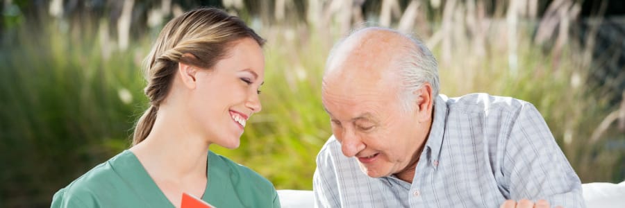 Resident being read to by a caregiver at The Residences on Forest Lane in Montello, Wisconsin