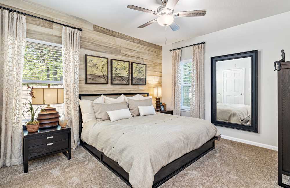 Bedroom with large windows at The Crossings At Nine Mile Road in Pensacola, Florida