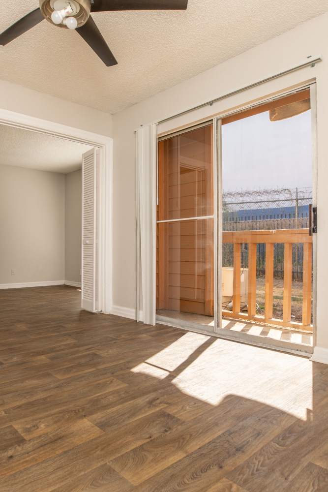 Wood-style flooring and ceiling fan at Fredericksburg Place Apartments in San Antonio, Texas