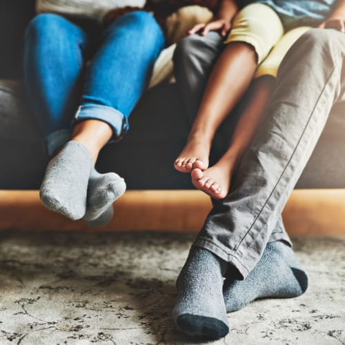 A family's feet on a couch in a home at Eagleview in Joint Base Lewis McChord, Washington