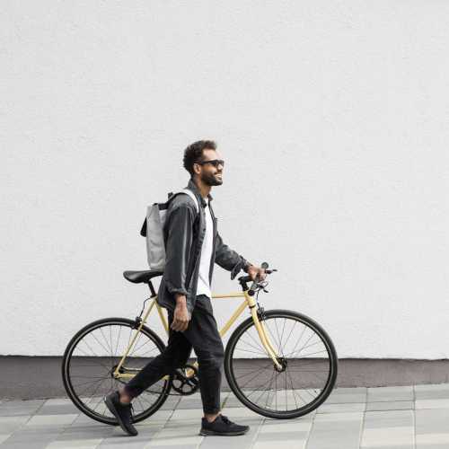 Man with his bike in downtown near Parcwood Apartments in Corona, California