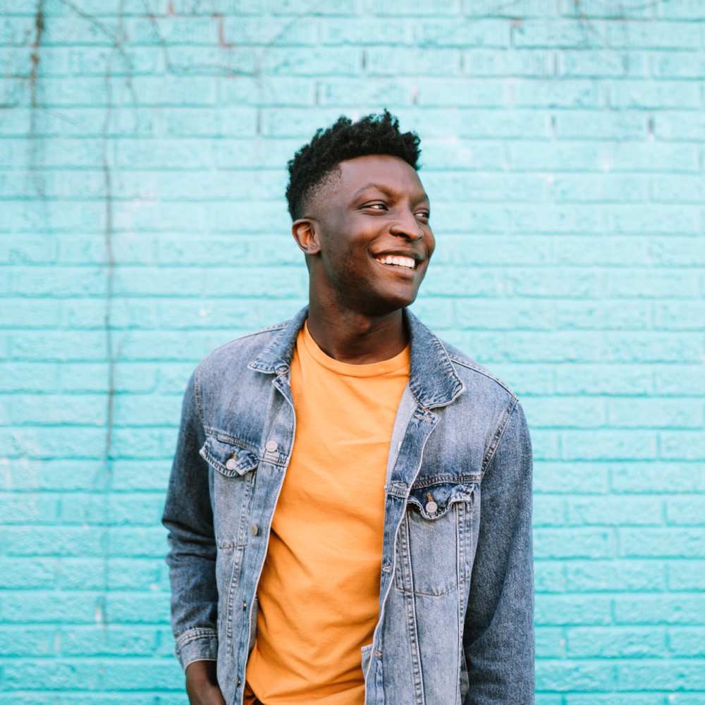 Resident in front of a colorful wall near 1801L Apartments in Sacramento, California