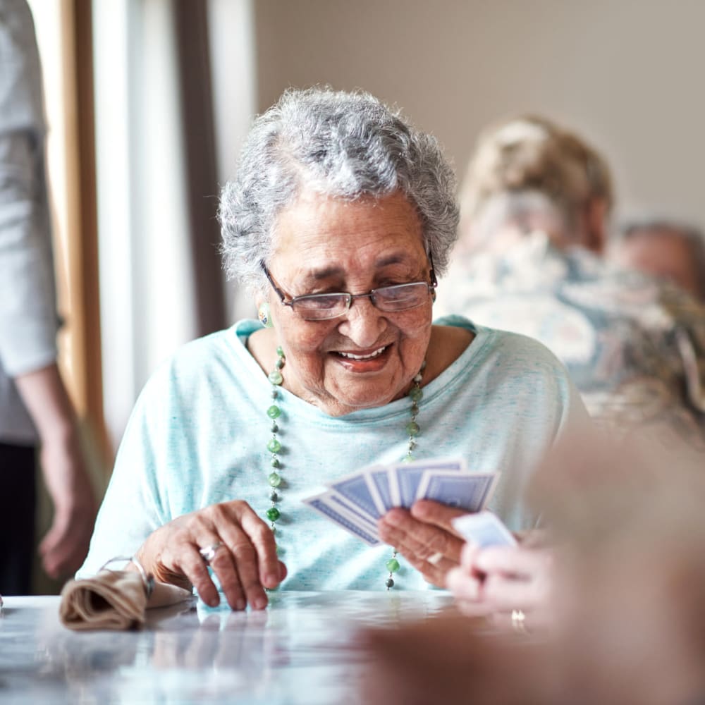 A resident playing cards at Alder Bay Assisted Living in Eureka, California