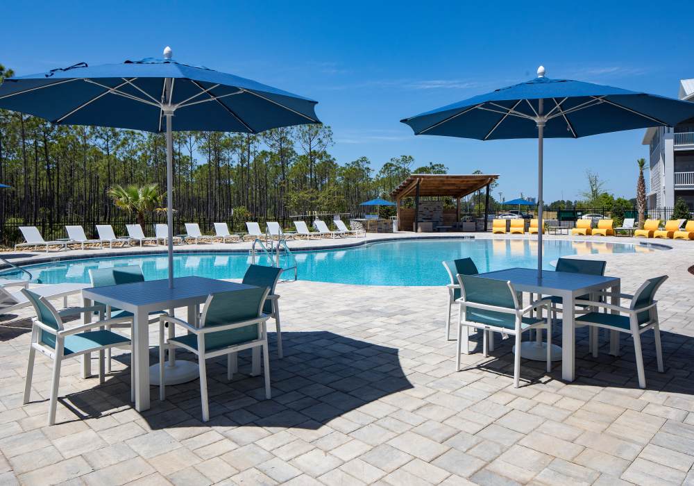 A swimming pool with lots of lounge chairs at Pier Park Crossings in Panama City Beach, Florida