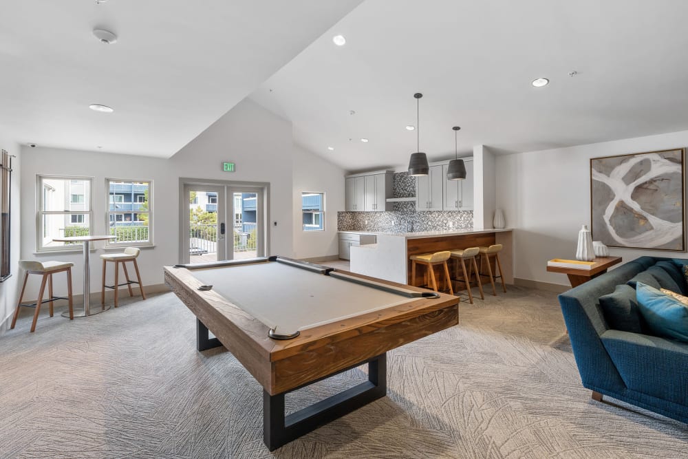 Clubhouse with pool table, kitchen, and sitting area at Ballena Village Apartment Homes in Alameda, California
