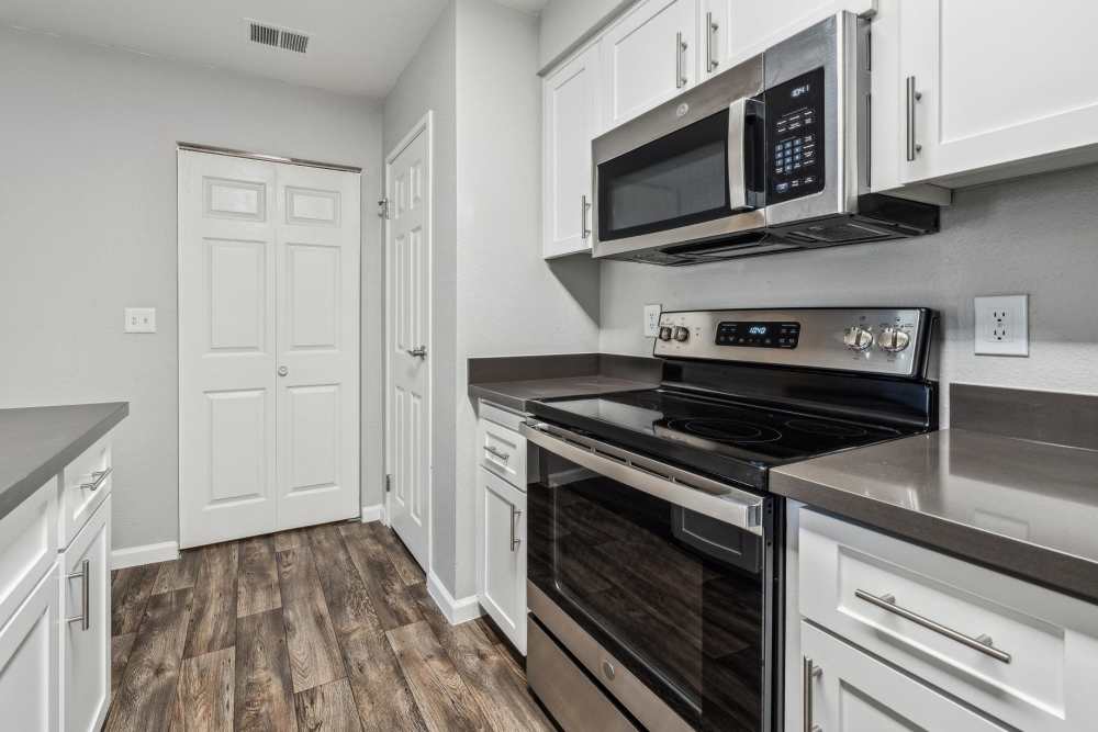 Apartment kitchen with stainless-steel appliances at Sterling Heights Apartment Homes in Benicia, California