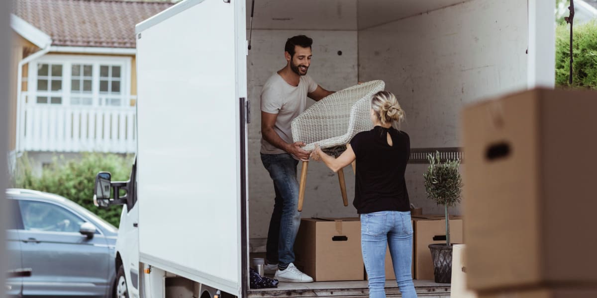 Couple loading a moving truck near Another Closet Storage