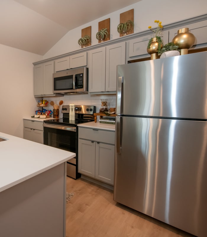 Model kitchen with stainless appliances at Chisholm Pointe in Oklahoma City, Oklahoma