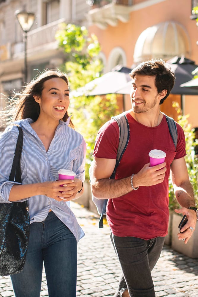 Two people drinking coffee near 55 Brighton at Packard Crossing in Boston, Massachusetts