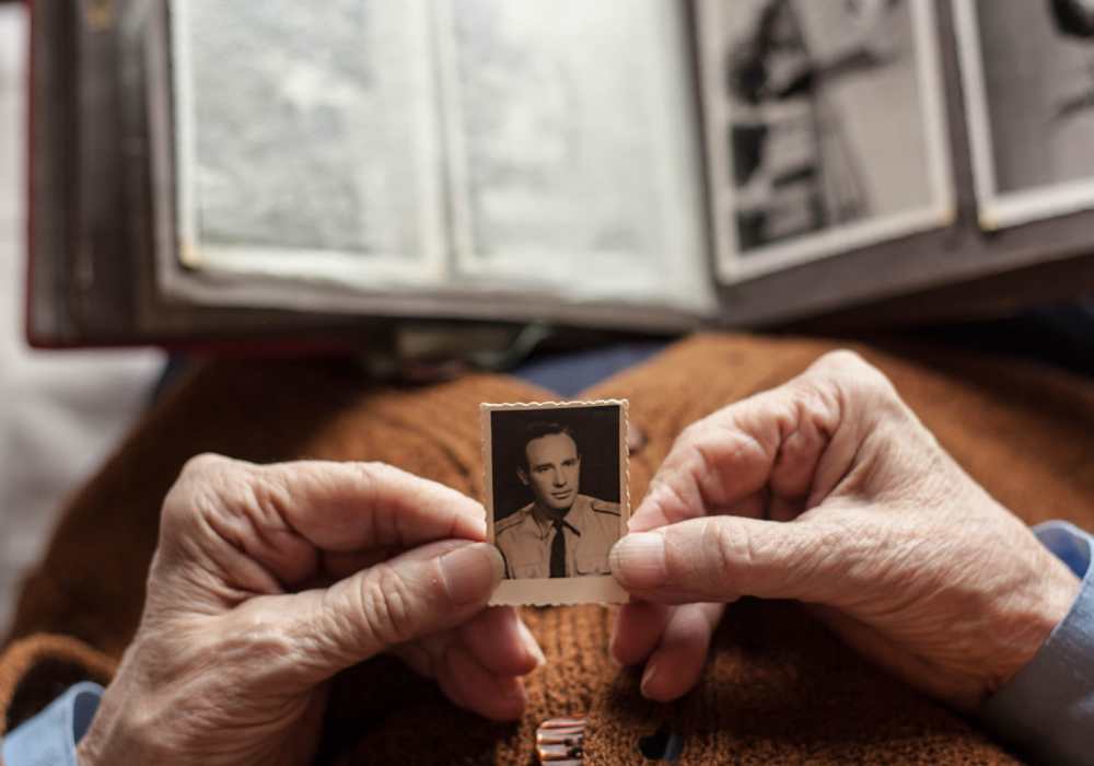 Resident holding an old photo at Merrill Gardens in Seattle, Washington