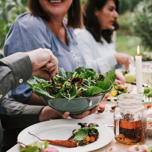 Residents sharing a meal at Harbor Oaks Apartments in Sacramento, California