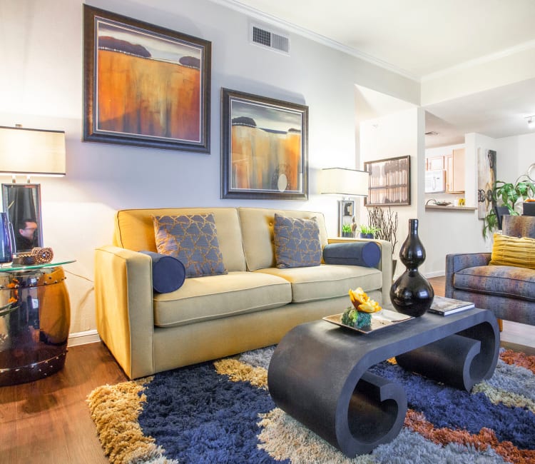 Living area with hardwood floors in a model home at Riata Austin in Austin, Texas
