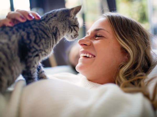 Resident and her happy cat in their pet-friendly home at K Street Flats Apartment Homes in Berkeley, California