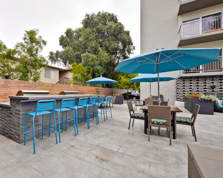 Barbecue area with shaded seating at Mia in Palo Alto, California