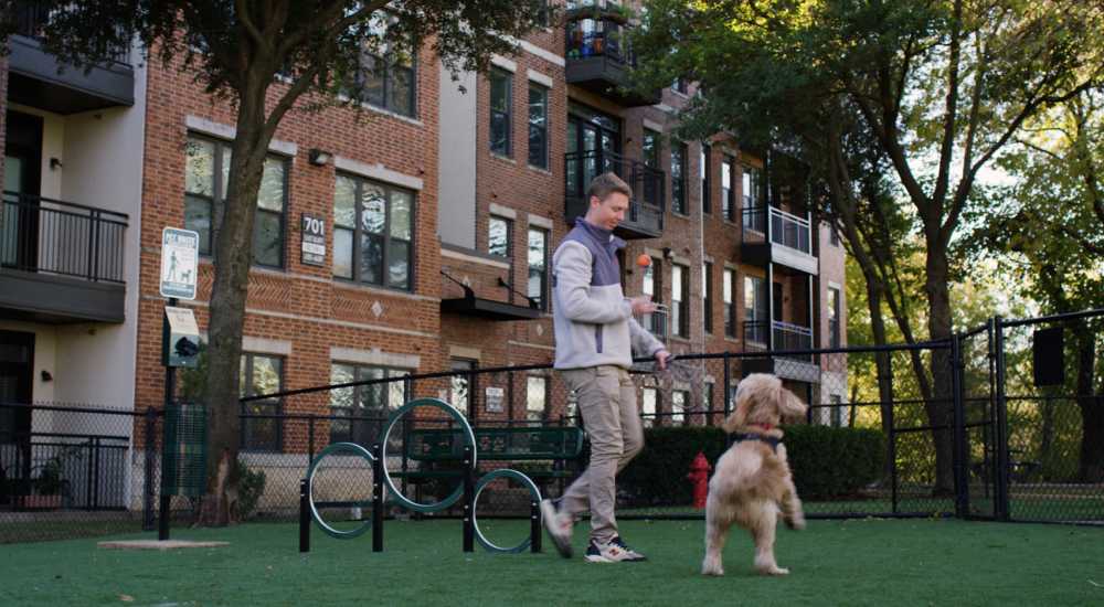 Resident and his dog playing at Trinity Bluff & Trinity District in Fort Worth, Texas 