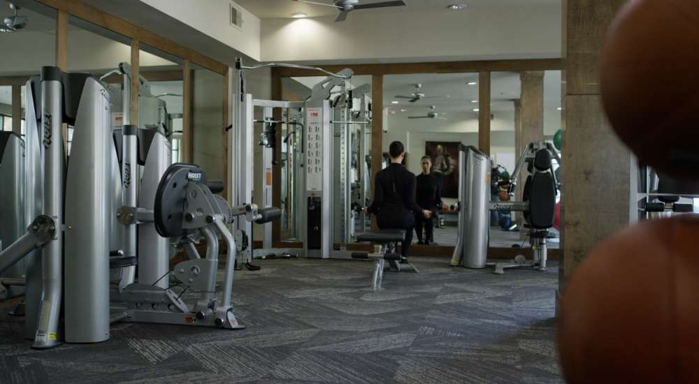 Resident exercising in the gym at Trinity Bluff & Trinity District in Fort Worth, Texas 