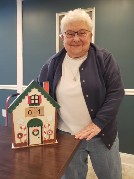 An Arbour Square (PA) resident shows off their wonderfully painted gingerbread house!
