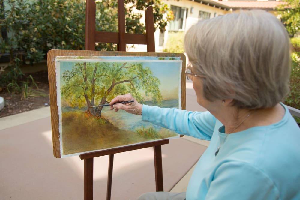 A resident painting at Merrill Gardens at Greenville in Greenville, South Carolina. 