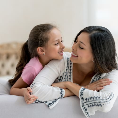 A mother with her daughter laying on the bed at Ben Moreell in Norfolk, Virginia