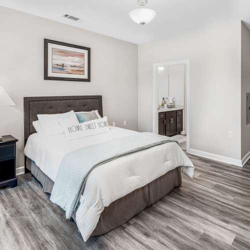 Bedroom with cozy bed and large window at Groves at Waters Edge in Waynesville, North Carolina