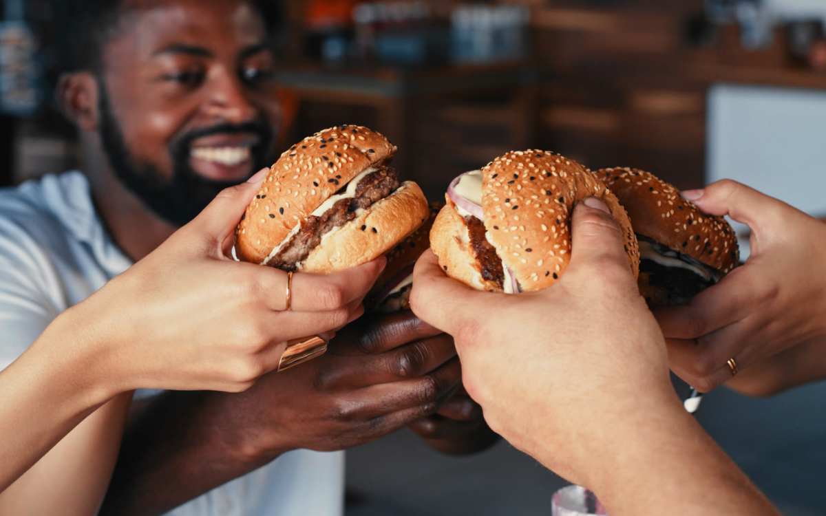 Residents having burgers at a restaurant near Pelican Isles Apartments in Sebastian, Florida