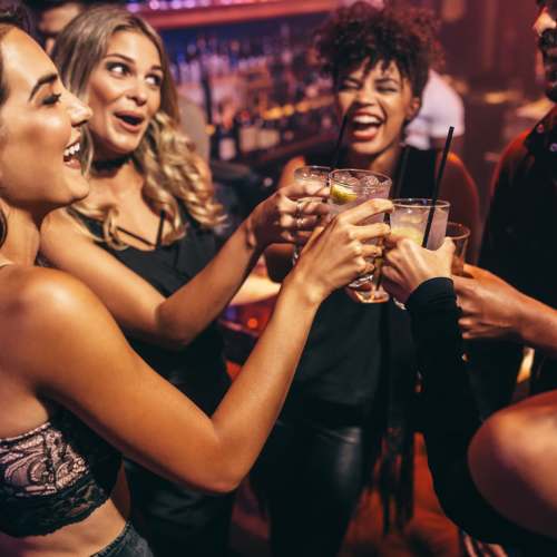 Friends out for drinks at a bar near Ventura Park Plaza Apartments in Portland, Oregon