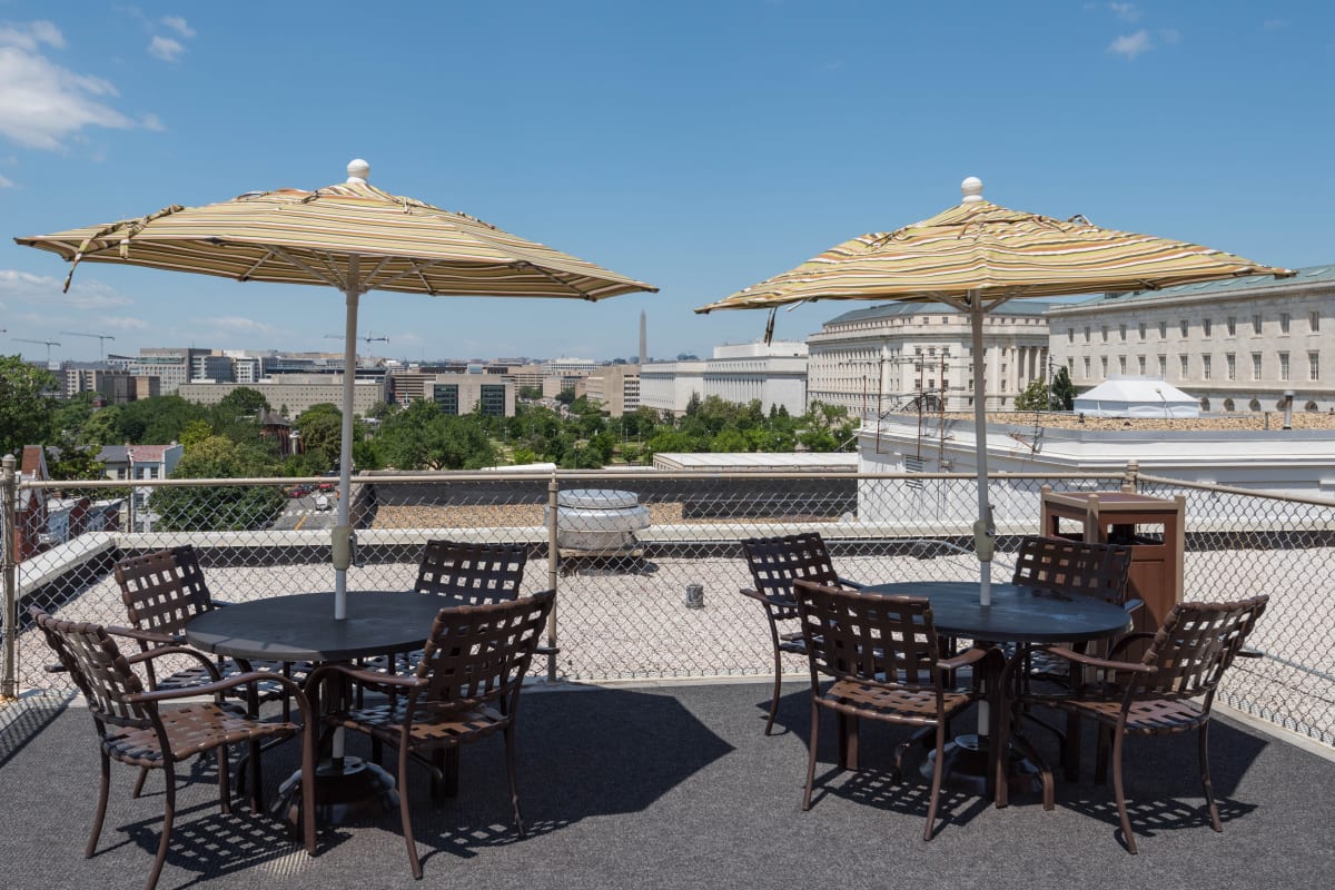 Spacious tables on top of the private rooftop patio with great views of the city at Hill House in Washington, District of Columbia