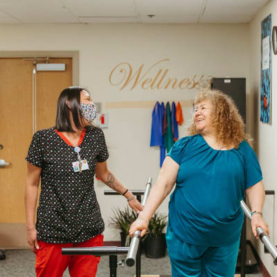 Certified nurse working with a resident on the treadmill at Cascade Park Adult Day Health in Tacoma, Washington