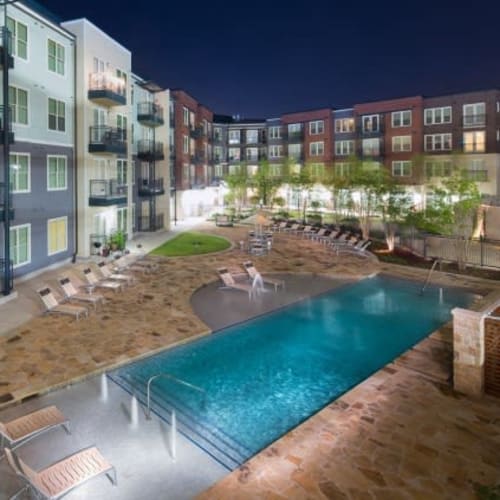 Resort-style swimming pool area in the early evening at Union At Carrollton Square in Carrollton, Texas