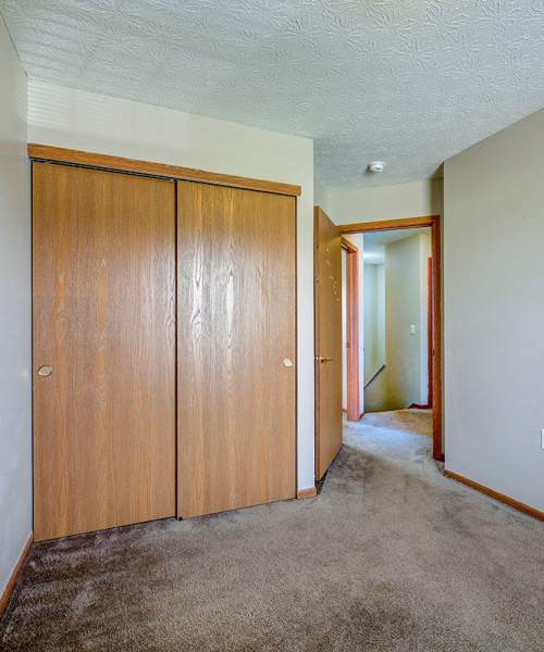 Wooden closet doors in a carpeted hallway at Orchard Glen in Orrville, Ohio