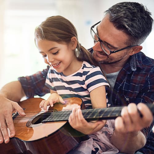 Father playing a guitar with his daughter at Prospect View in Lakeside, California