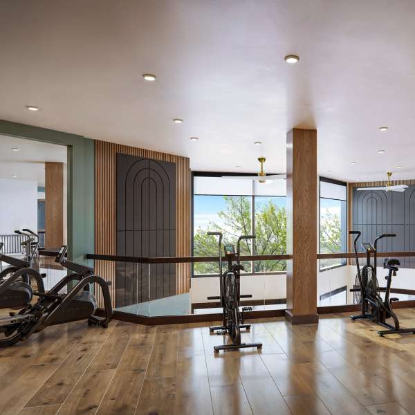 Fitness room with wood-style floors and exercise machines with a view at Flora + Fauna in San Diego, California